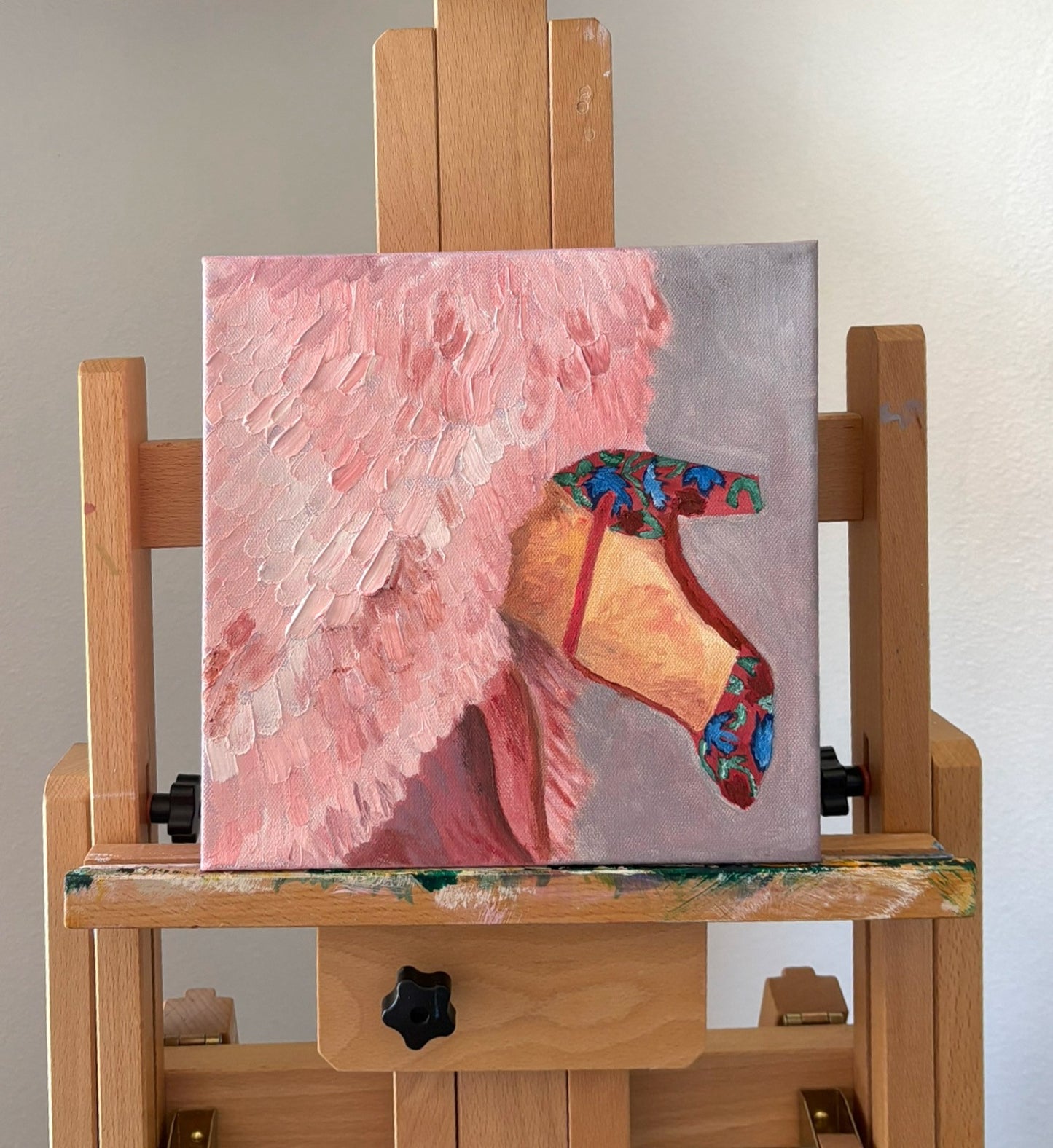 Painting of a Fashion Shoe and pink feathered dress on the artist easel. Original art by Robin Barrett Wilson. Robin Wilson Studio